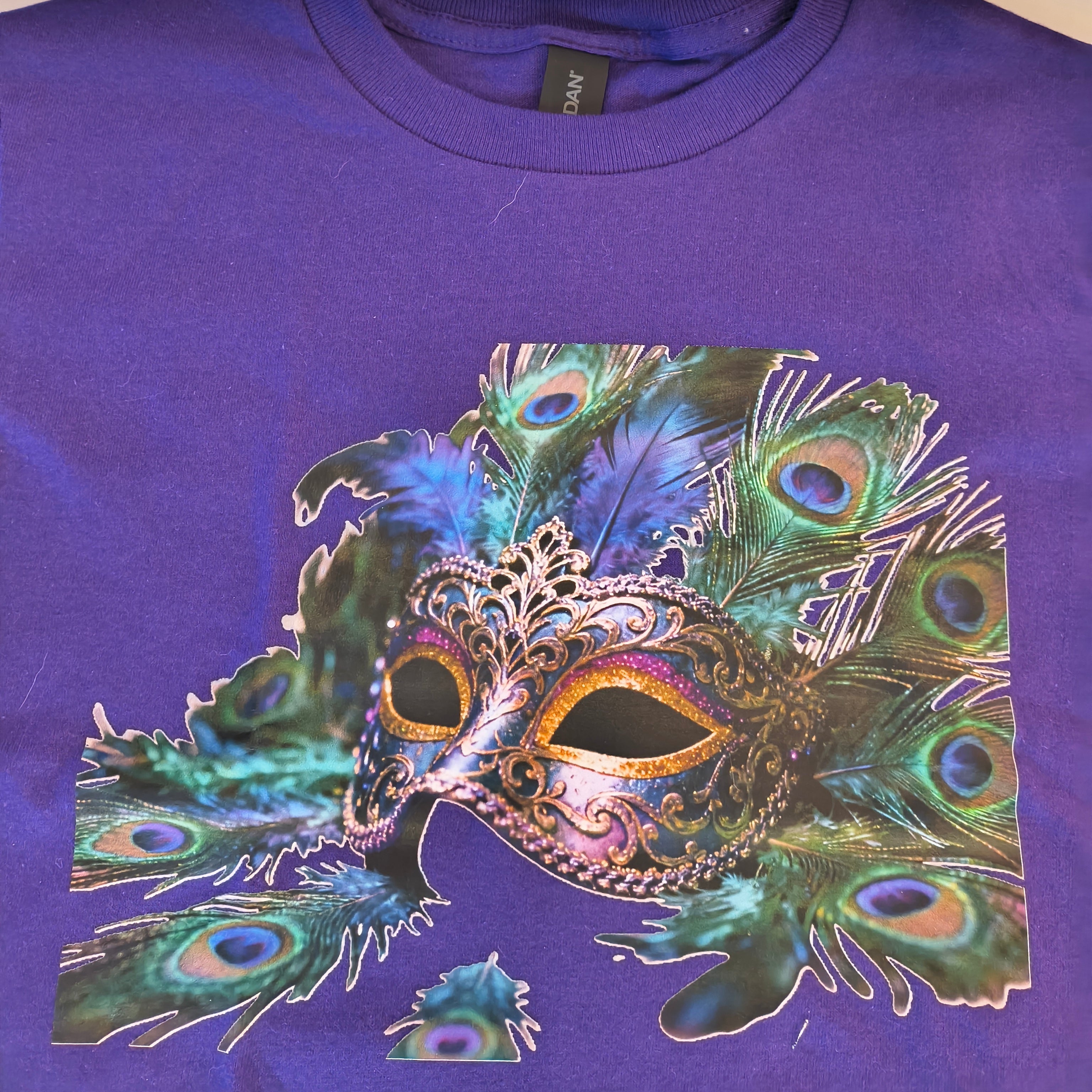 Short Sleeve T-Shirt, purple, 100% cotton, beautiful Peacock mask graphic with artist designed cotton trim on arms and bottom hem.