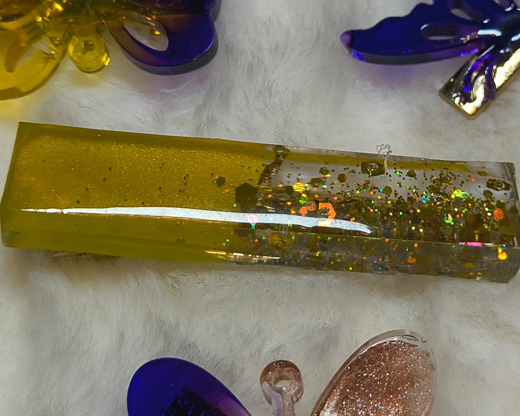 Hair Clips, Four in the set, three butterfly clips in multi color sparkled resin and one long clip yellow/gold sparkles