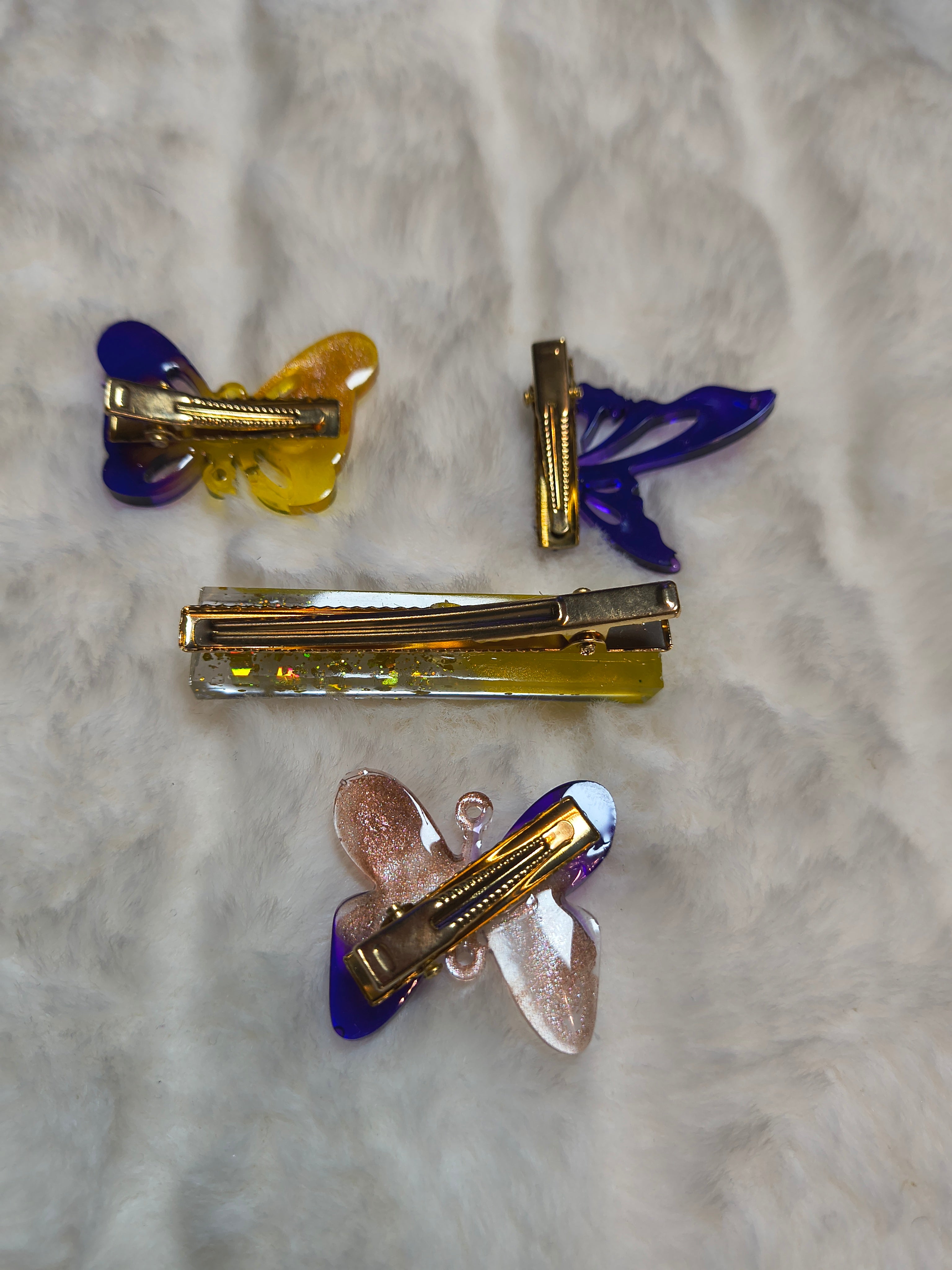Hair Clips, Four in the set, three butterfly clips in multi color sparkled resin and one long clip yellow/gold sparkles