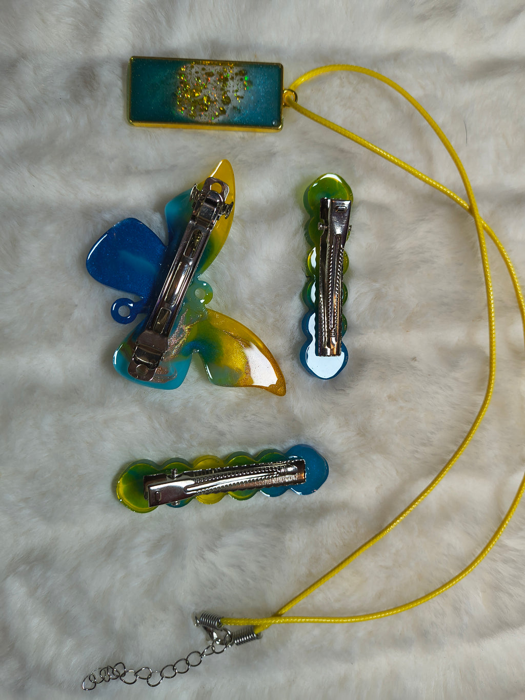Hair Clips, Set of three clips and a necklace, all in complimentary colors, two of the clips are same style, and a butterfly