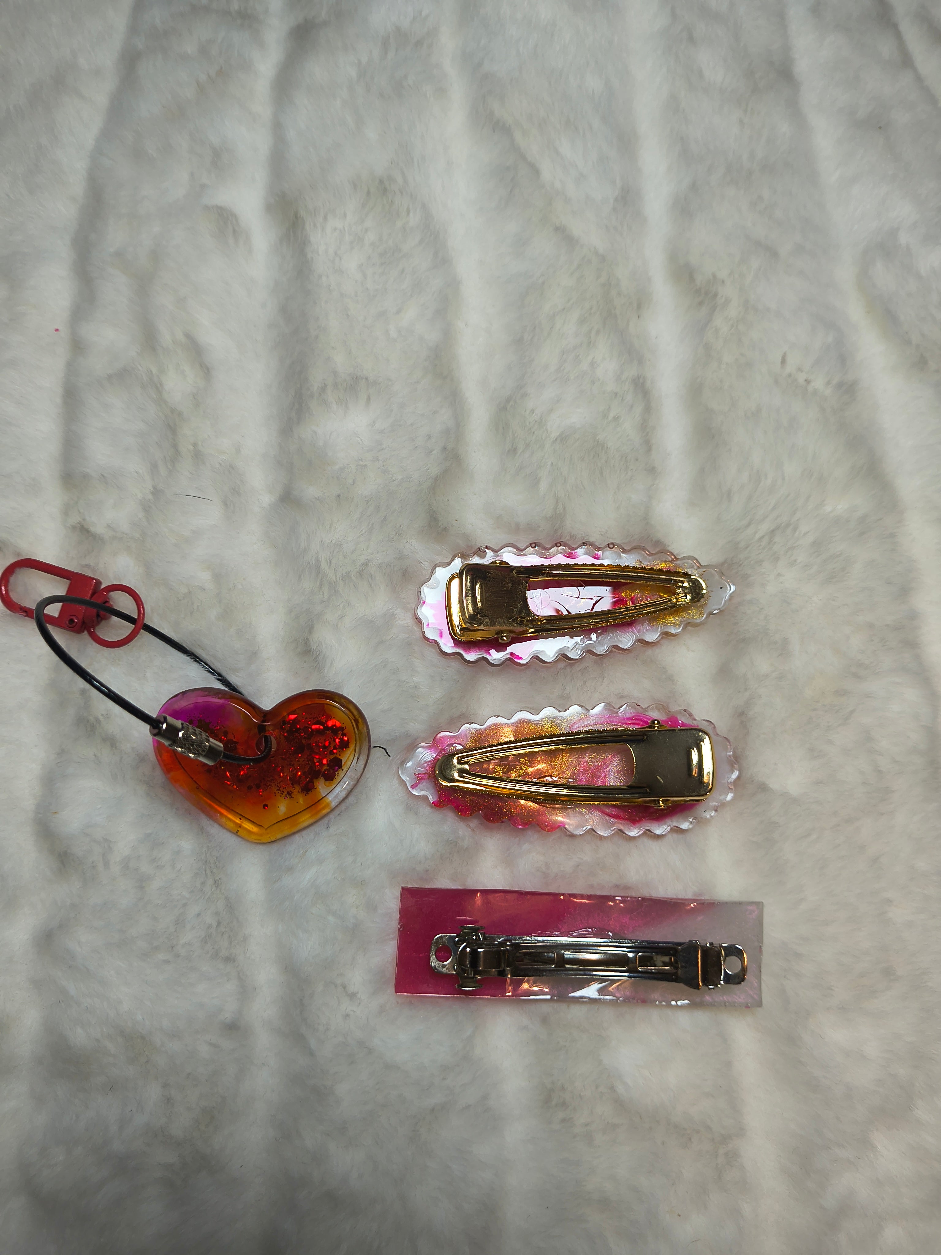 Hair Clips, three hair clips in beautiful pinks and gold.  Two match in style and color, with a heart shaped Keychain in a sparkles, all are resin