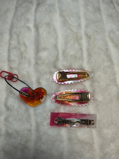 Hair Clips, three hair clips in beautiful pinks and gold.  Two match in style and color, with a heart shaped Keychain in a sparkles, all are resin