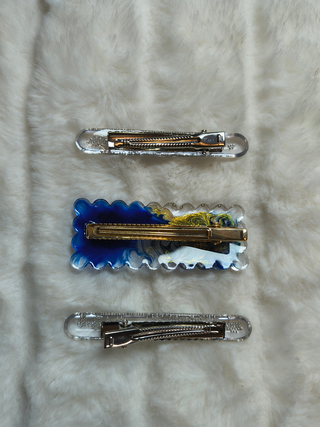 Hair Clips. Three in pack, two are matching in style with silver beads, one clip is in blue and gold swirls