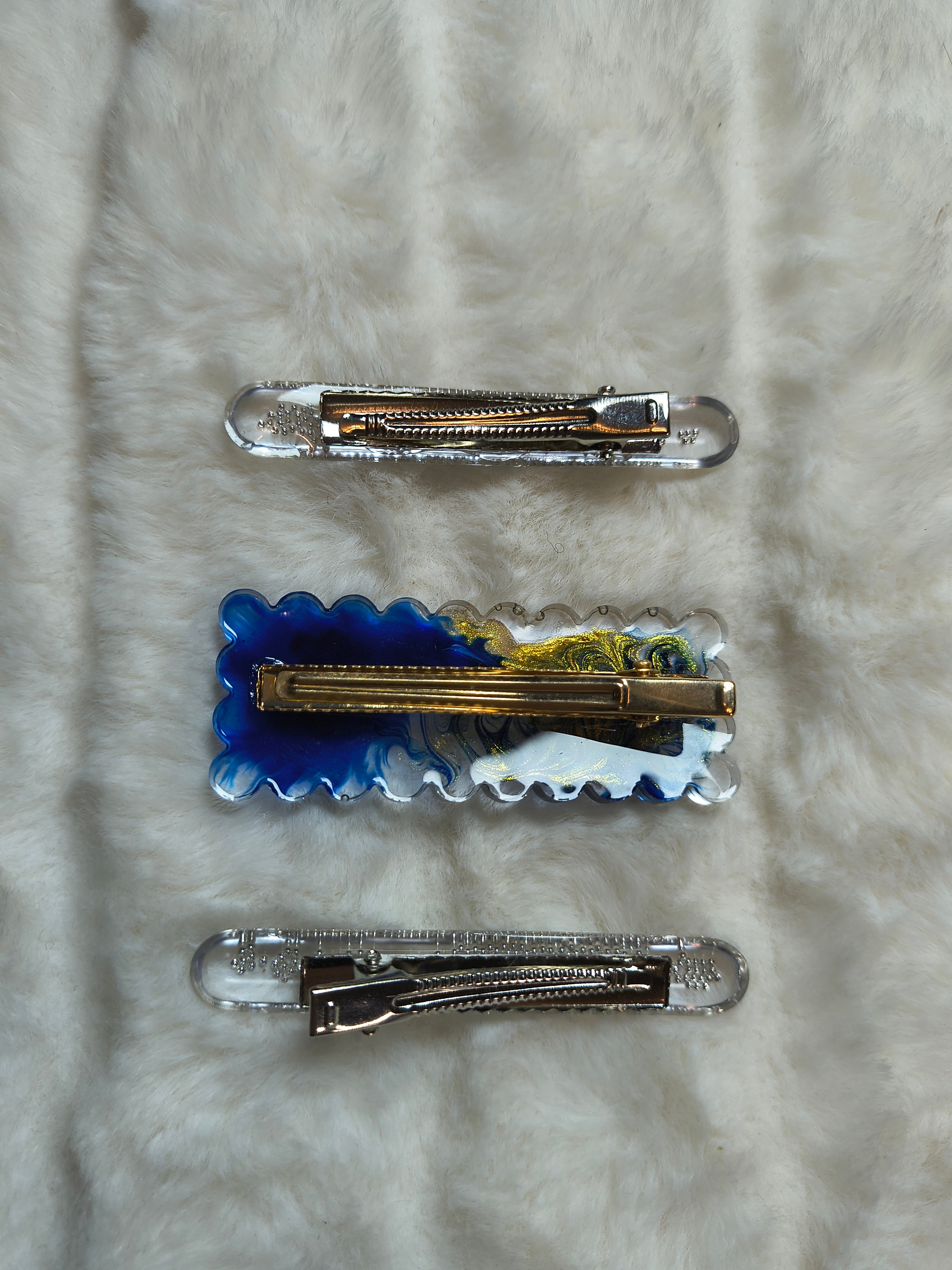 Hair Clips. Three in pack, two are matching in style with silver beads, one clip is in blue and gold swirls