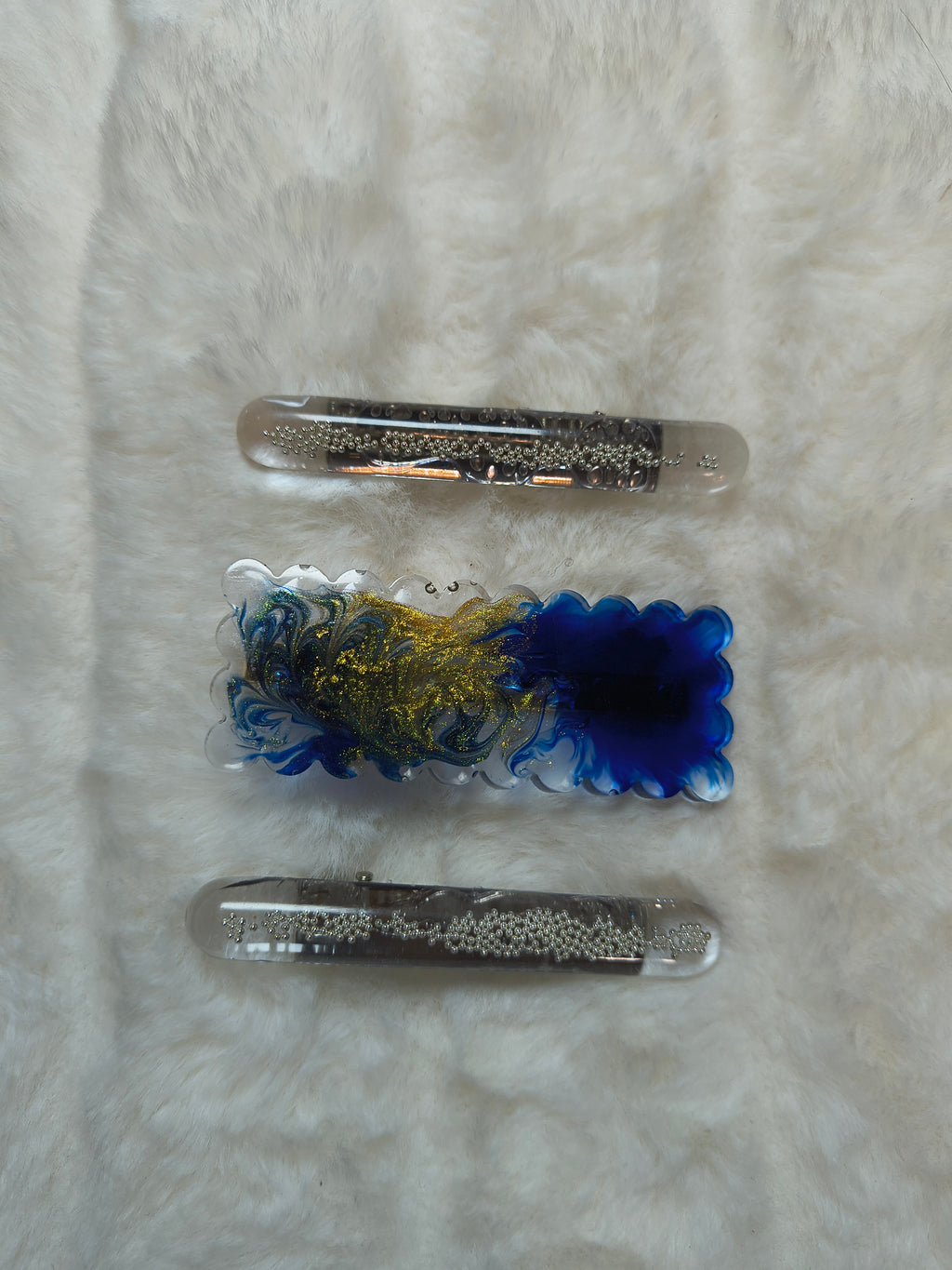 Hair Clips. Three in pack, two are matching in style with silver beads, one clip is in blue and gold swirls