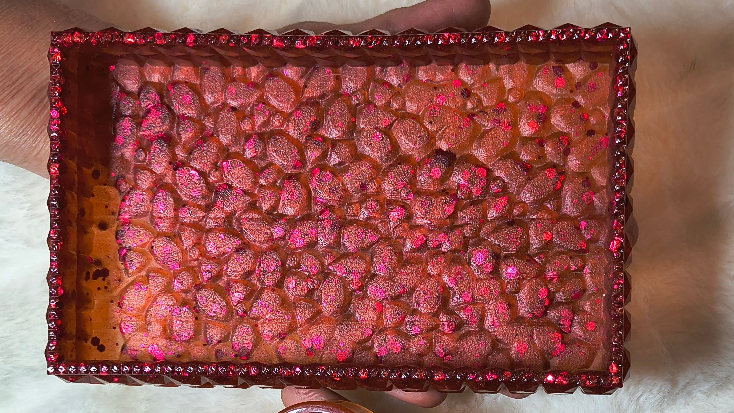 Close of of brick red sparkling tray for trinkets