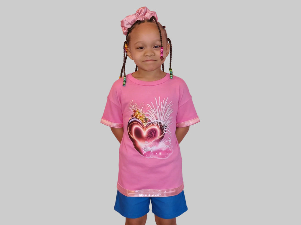 Short Sleeve T-Shirt, Vibrant Heart designed pink shirt that catches the eye of any child with a pink satin Trim on sleeves and bottom seam.