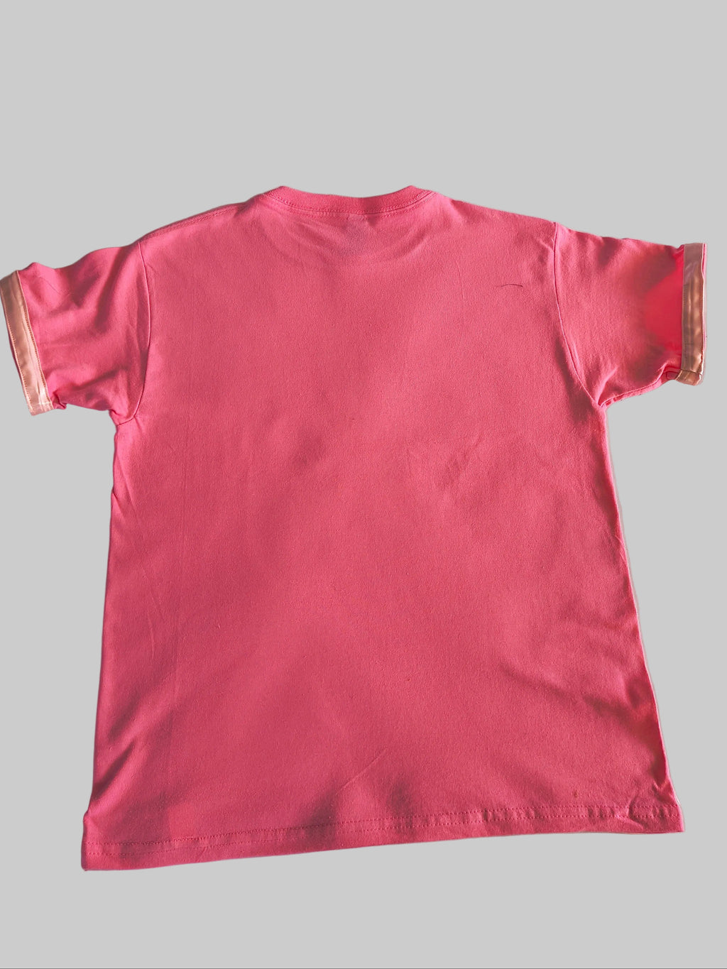 Pink t-shirt with pink satin trim on a sleeves back view of shirt