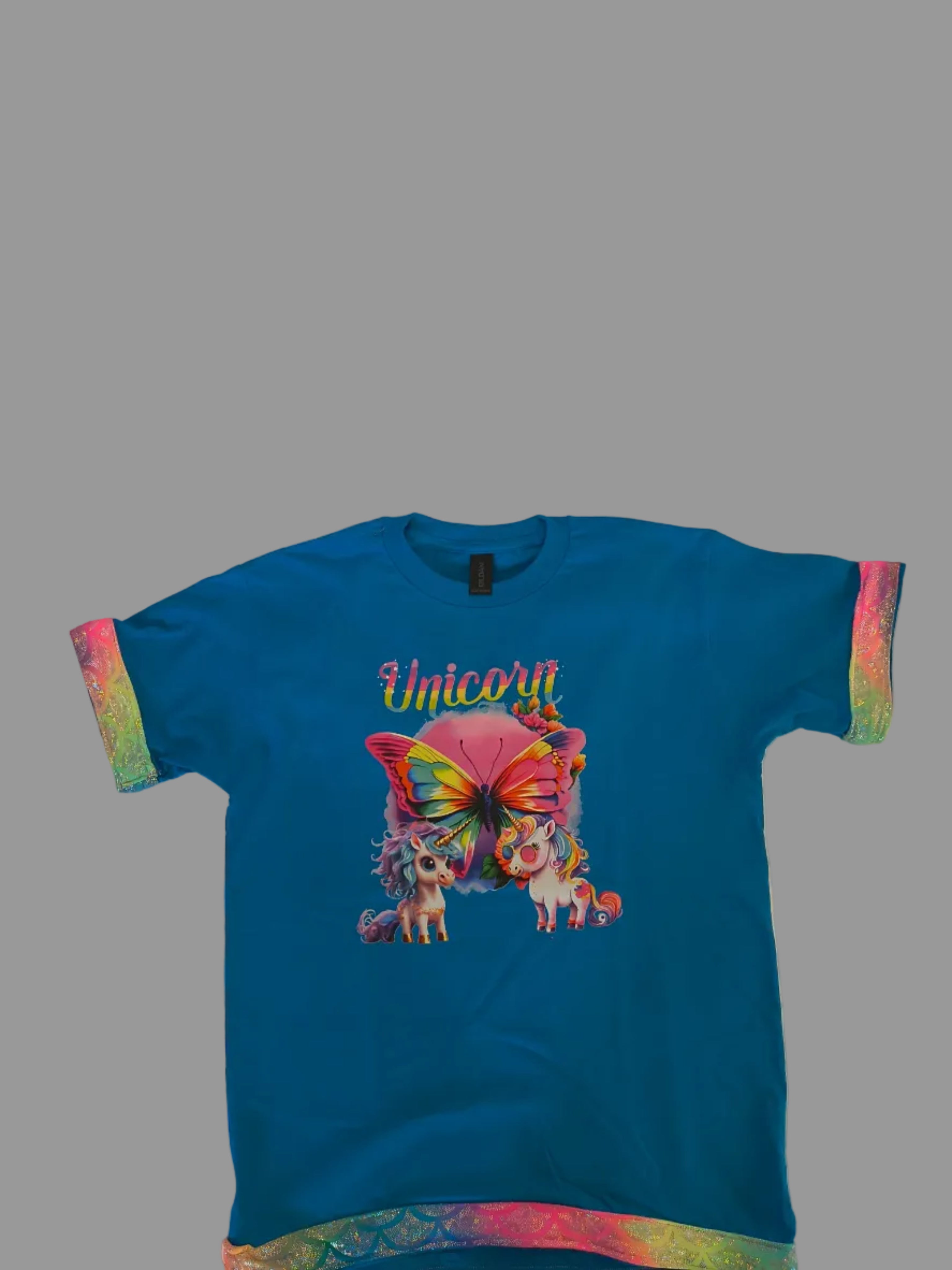 Short Sleeve T-Shirt, Turquise, 100% cotton. Unicorns and Butterfly graphic with a multicolor fabric trim that sparkles around sleeves and bottom of shirt