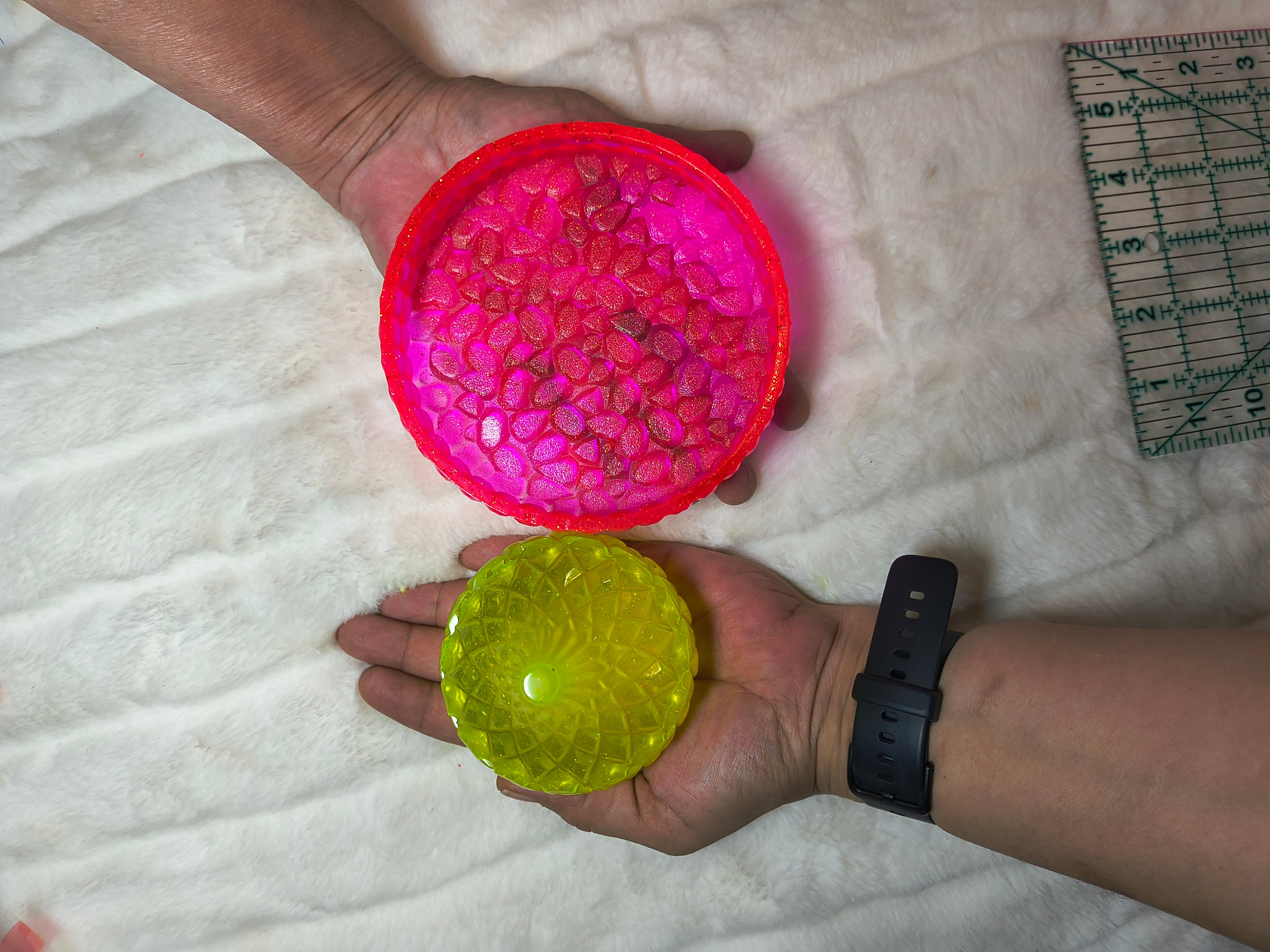 Handcrafted neon pink and lemon yellow resin trinket holder set of 2 shown in hand